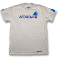 A white short-sleeve crewneck t-shirt featuring a blue 'NORDAIR' logo and a blue wing graphic on the chest, with additional blue graphics on the sleeves and a small logo near the bottom hem.