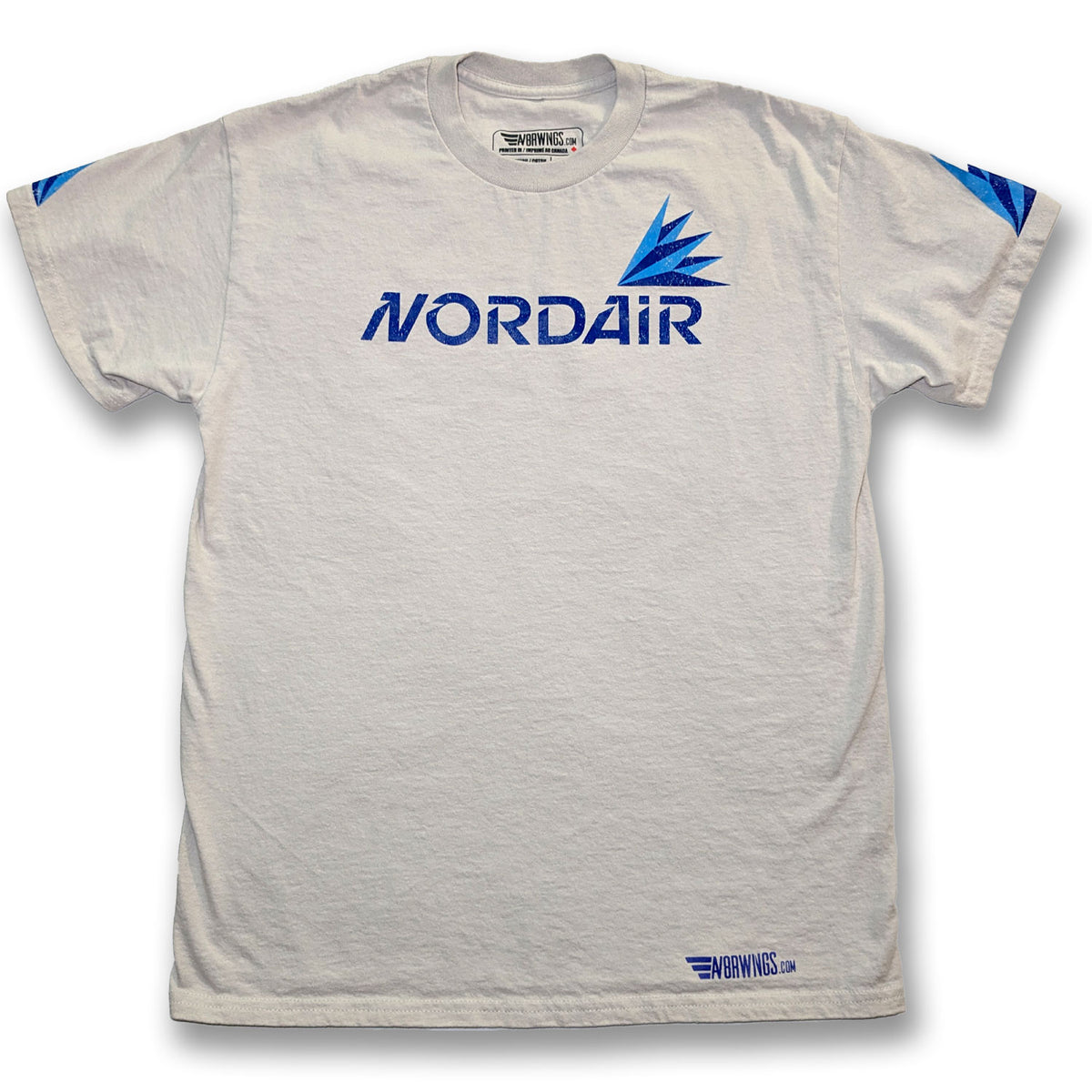 A white short-sleeve crewneck t-shirt featuring a blue 'NORDAIR' logo and a blue wing graphic on the chest, with additional blue graphics on the sleeves and a small logo near the bottom hem.