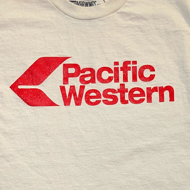 Close-up of a light beige or off-white t-shirt featuring a distressed red graphic of the Pacific Western airline logo on the chest.