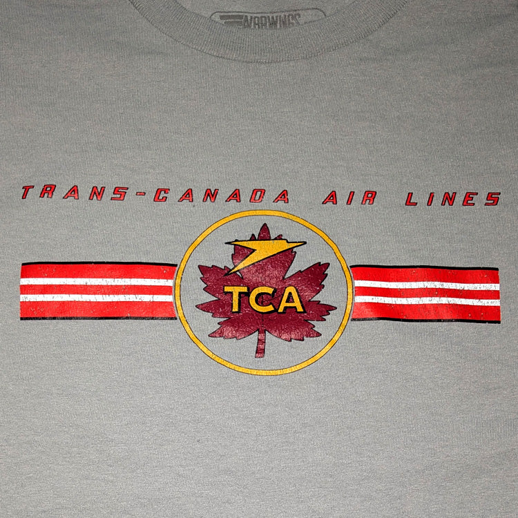 A close-up of a gray t-shirt featuring a distressed red and yellow Trans-Canada Air Lines graphic on the chest.